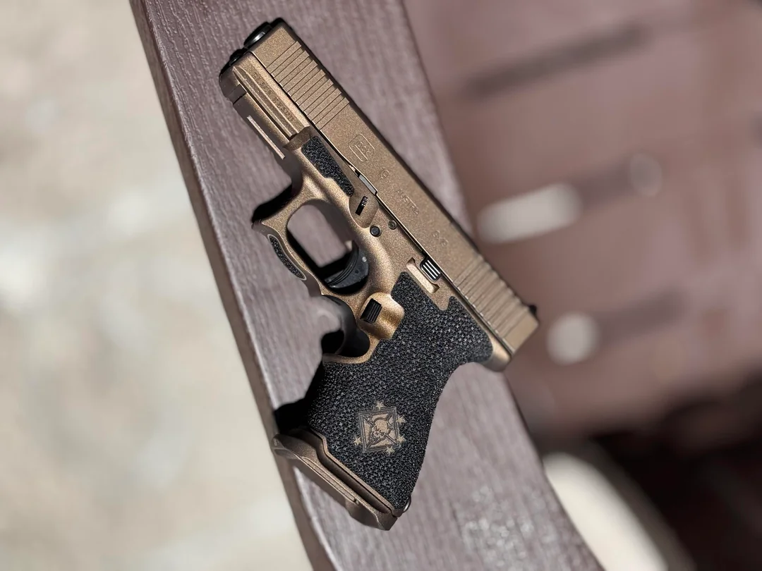 Glock 19 — Midnight Bronze — Bronze Cerakote · Engraved Grip