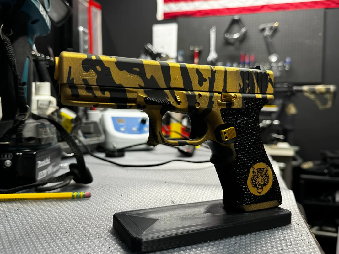 Glock 22 — Eye of the Tiger — Gold Tiger-Stripe Cerakote · Full Stipple
